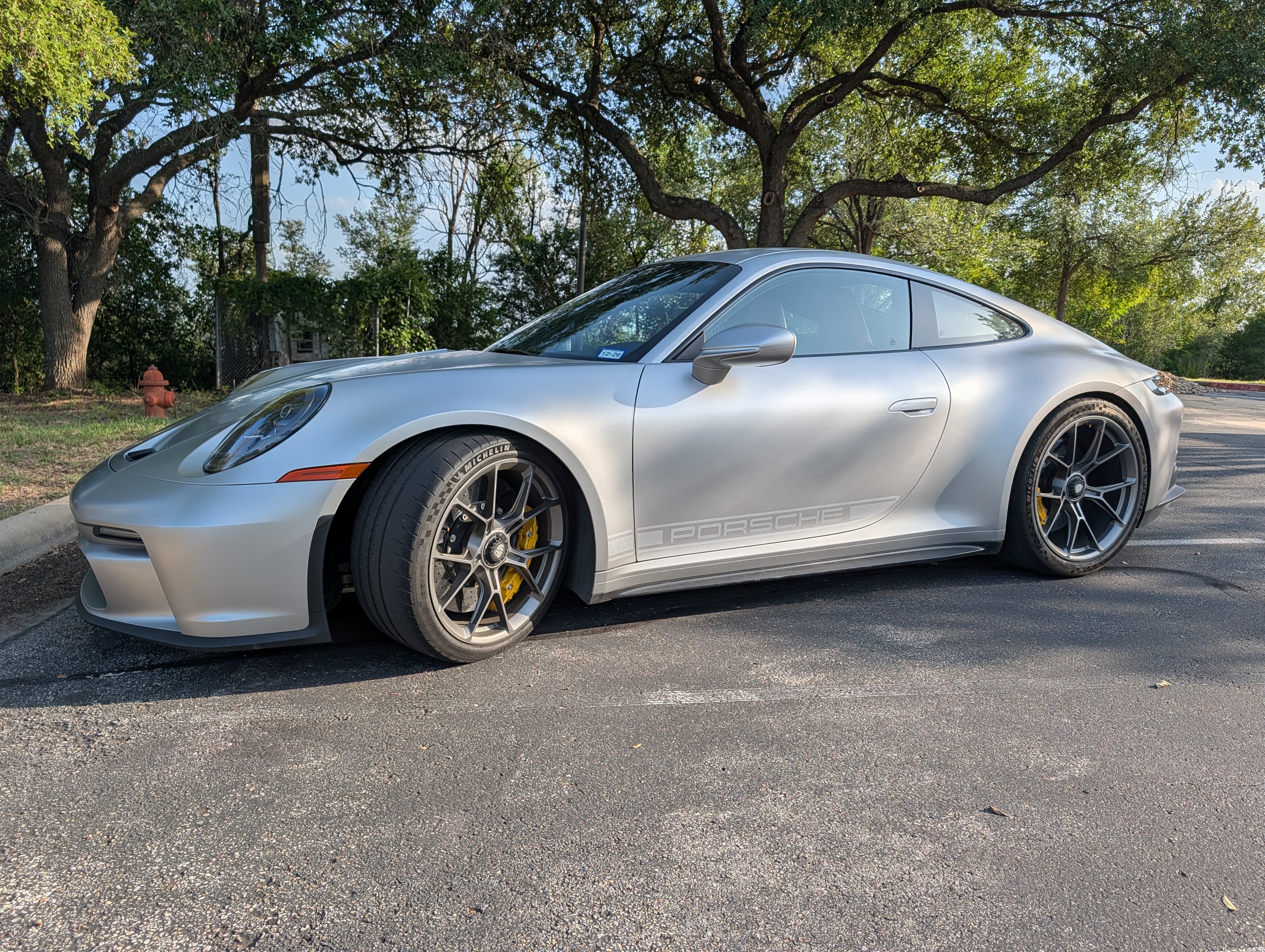 Side profile, tree-lined parking lot