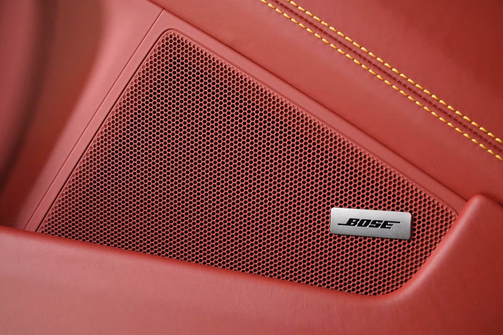 Door panel Bose speaker grille with yellow deviated stitching